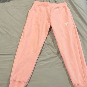 Medium light pink Nike sweat pants .